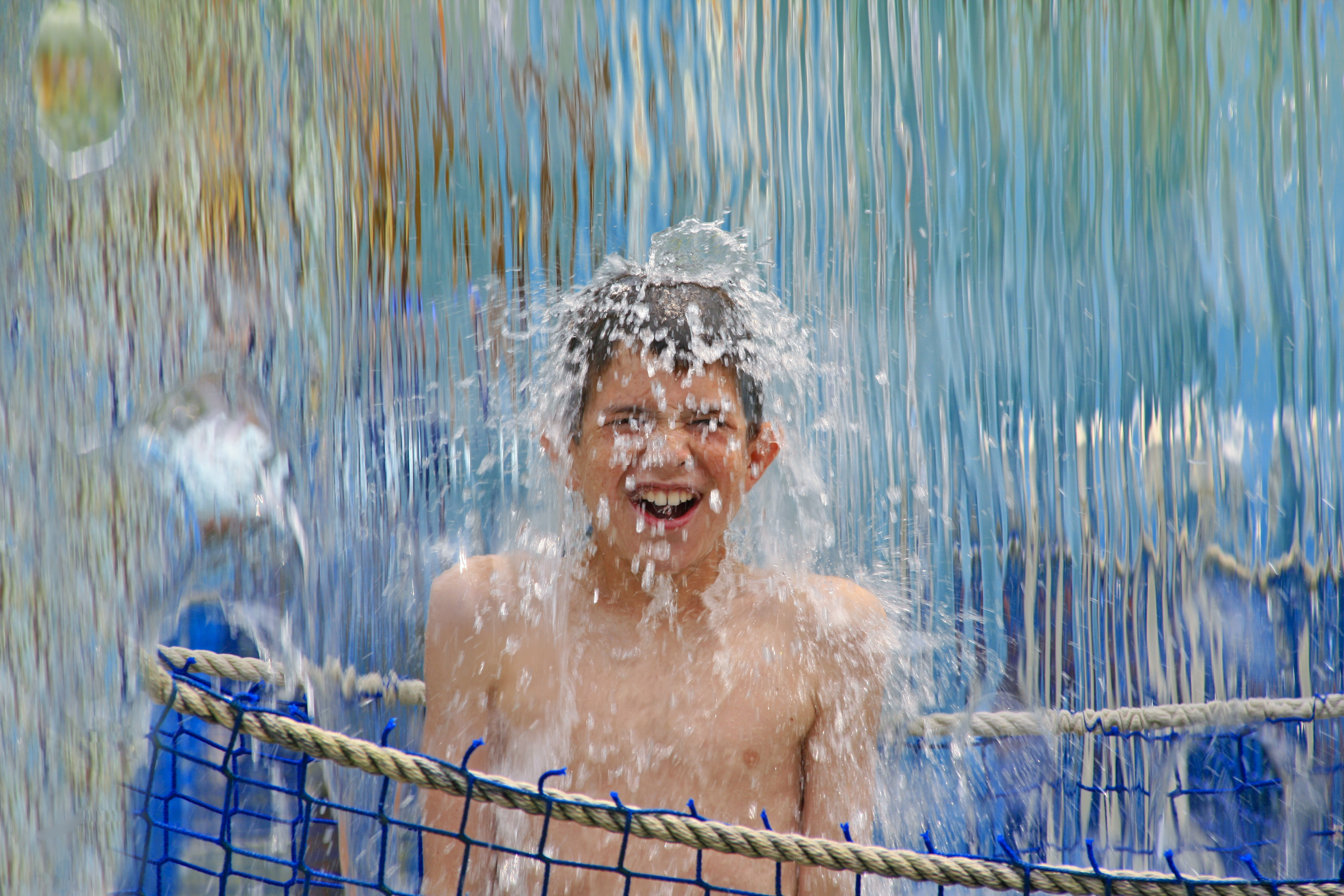 boy under waterfall